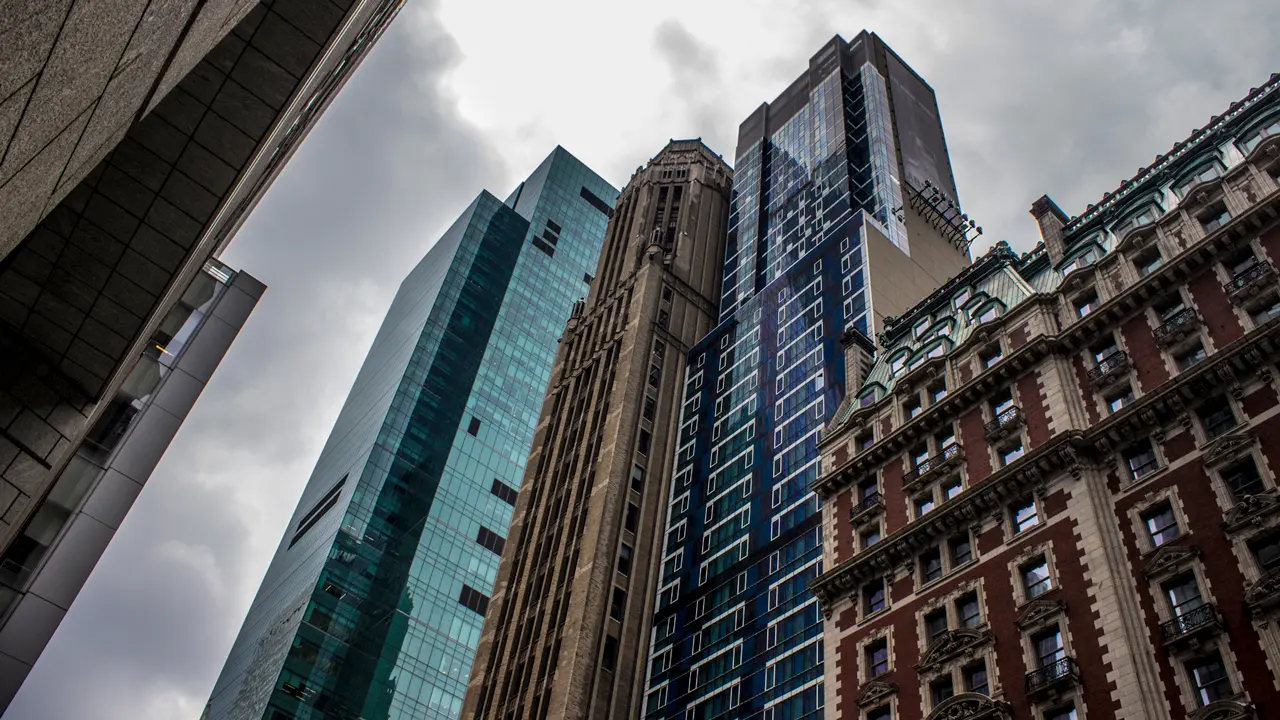 Three skyscrapers and a shorter building surrounding 42nd Street in Manhattan.