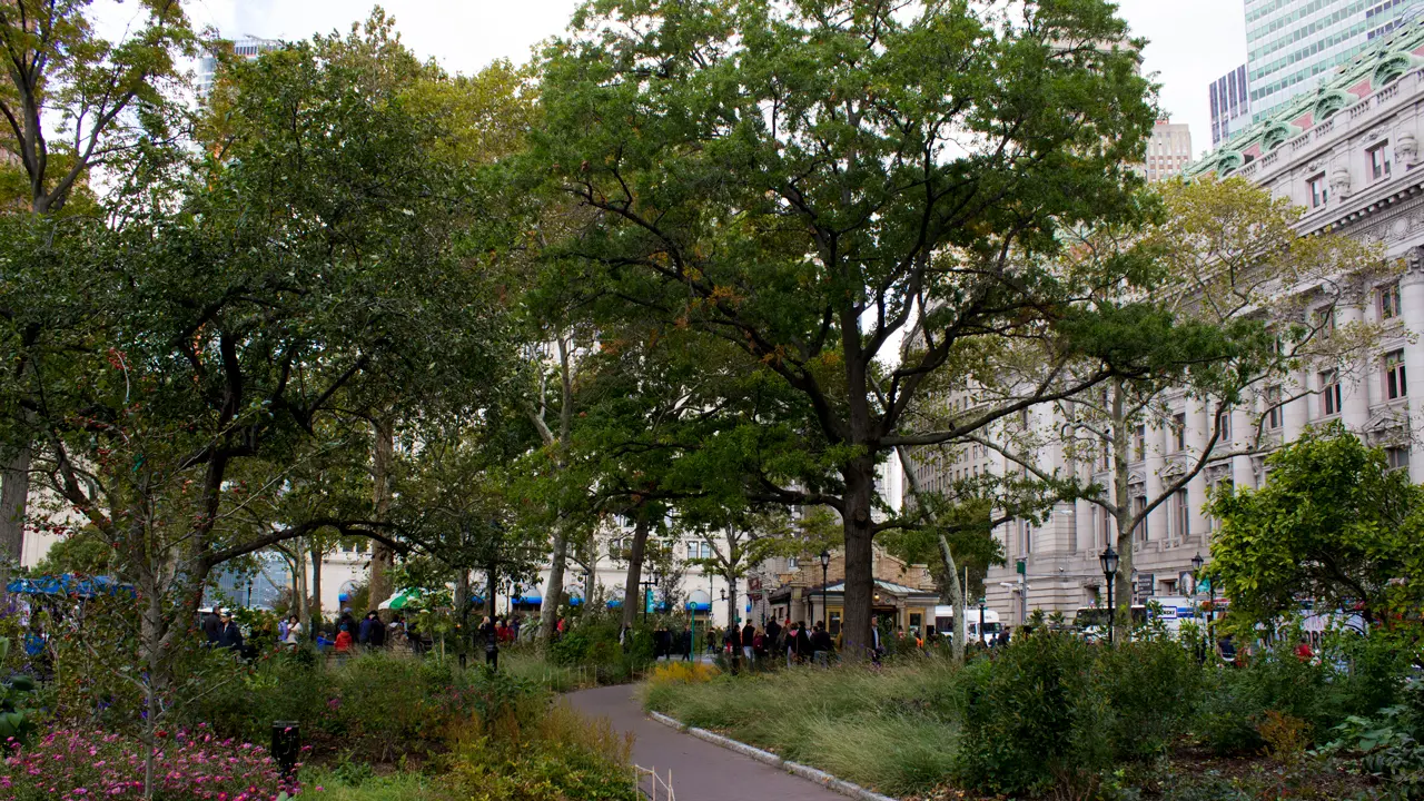 People utilizing the Bowling Green subway station in the distance.