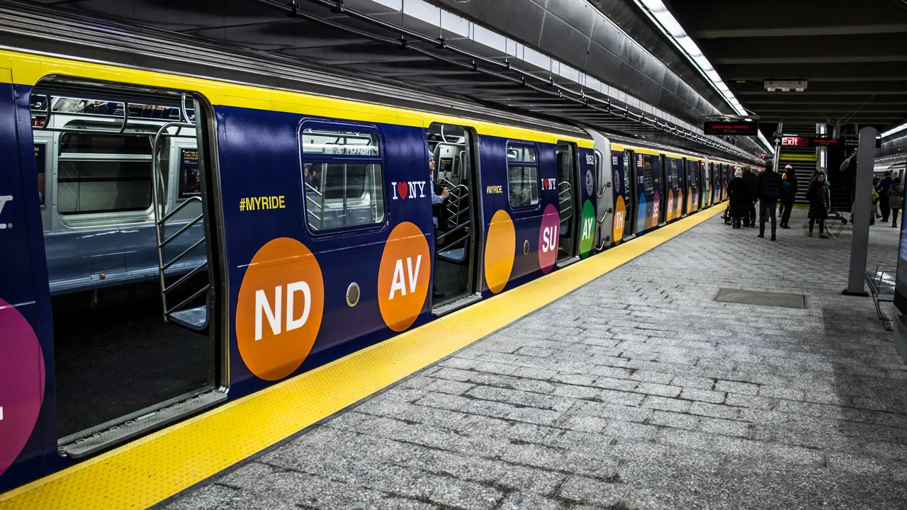 MTA Q train stopped at a station.