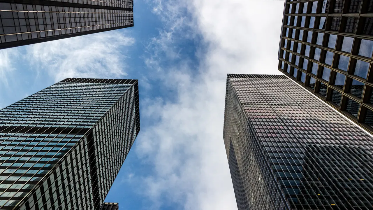 Looking at the tops of four skyscrapers.